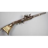 A Middle Eastern Flintlock Rifle with Brass Mounts, Substantial Condition Issues