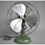 A Vintage Green Enamelled Table Top Fan by Frost, 42cm high