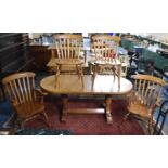 An Extending Oval Oak Dining Table with One Extra Leaf, Together with Four Dining Chairs to