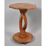 A Carved Wooden Octagonal Topped African Table, 52cm High