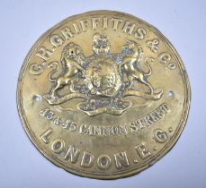 A Late Victorian/Edwardian Pressed Brass Circular Plaque for C H Griffis & Co., London, 17.5cm