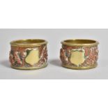 A Pair of Copper and Brass Napkin Rings Decorated in Relief with Figures on Horseback