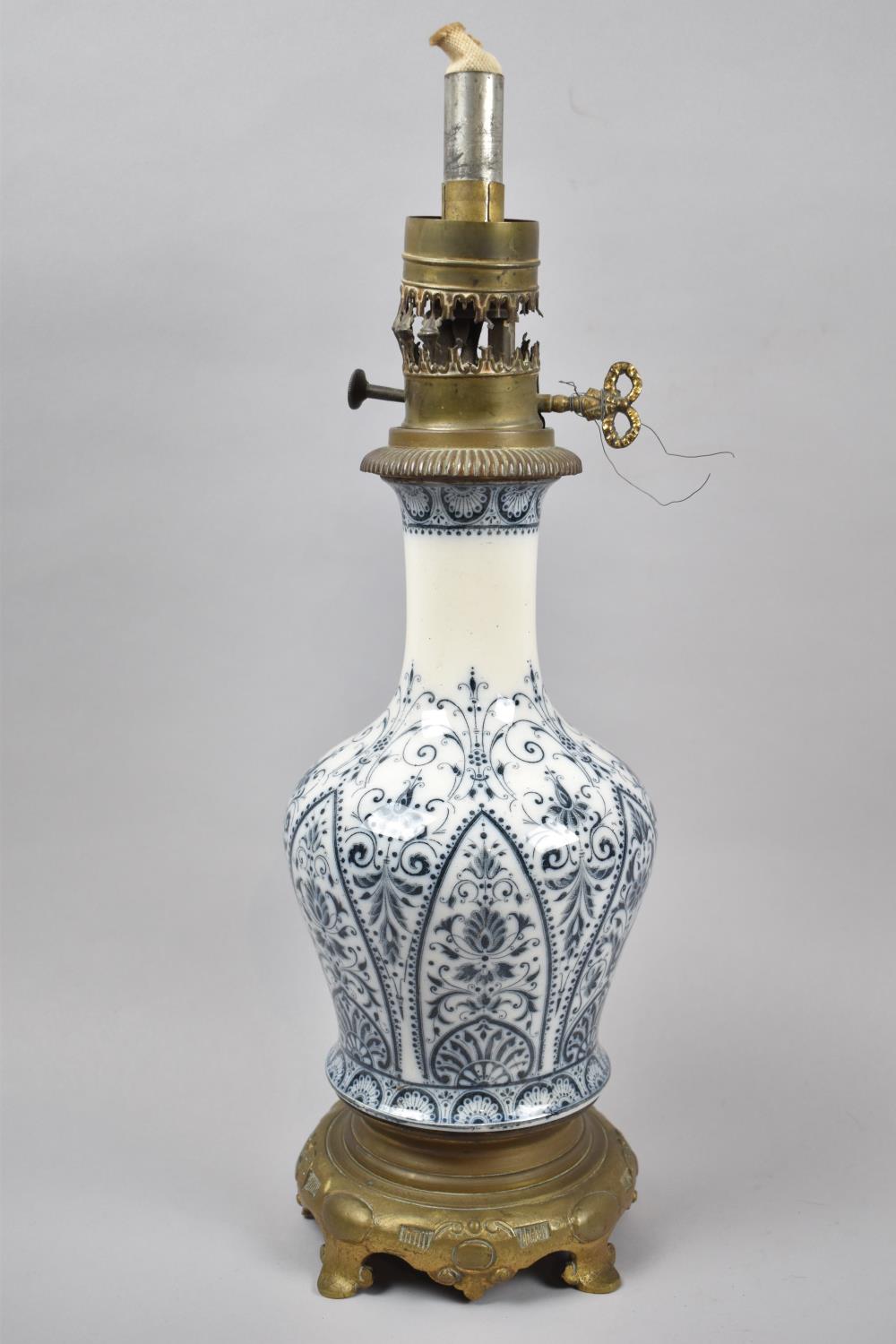 A Late 19th Century Blue and White Ceramic Vase Shaped Oil Lamp of Brass Circular Stand, 45cm High