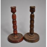 A Pair of Turned Wooden Bobbin Candlesticks on Circular Bases, 20cm high