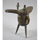 An Oriental Bronze Libation Cup of Archaic Form Raised on Three Feet, 18cm high