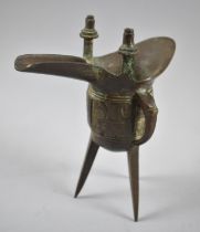 An Oriental Bronze Libation Cup of Archaic Form Raised on Three Feet, 18cm high