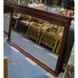 A Large Modern Mahogany Framed Oval Mantle Mirror with Reeded Supports, 176cm wide and 92cm high