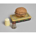 A Novelty Thimble Case in the Form of Walnut Shell on Stand, Containing Two Thimbles, One Ivory