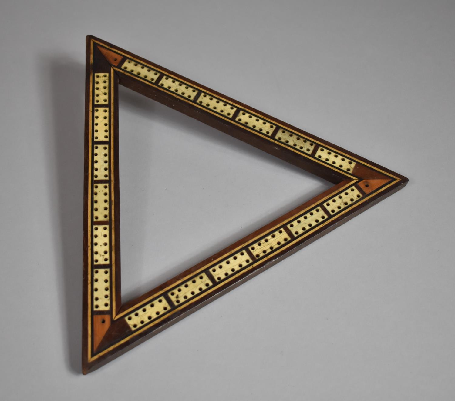 An Edwardian Colonial Cribbage Board of Triangular Form with Paper Store Under (No Pegs), Each