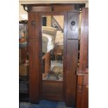 An Arts and Crafts Oak Mirror Fronted Wardrobe with Pressed Copper Panels and Heart Shaped Cabochon,