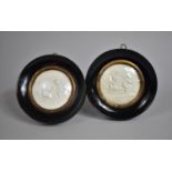 A Pair of Circular Ebonised Framed Relief Miniatures Depicting Cherubs Playing, 12.5cm Diameter