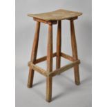 A Vintage Wooden Stool with Curved Seat