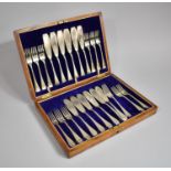 An Early 20th Century Oak Cased Canteen of Twelve Silver Plated Fish Knives and Forks