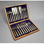 An Edwardian Mahogany Cased Canteen of Twelve Silver Plated Fish Knives and Forks