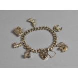 A Silver Charm Bracelet having Six Charms to include Duck, Bible, Church, Horse Bust in Horseshoe,