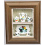 A Framed Diorama Depicting Teawares and Jugs on Shelves, 15x19cm