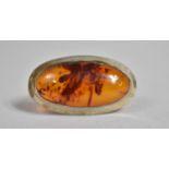 An Oval Silver and Amber Mounted Brooch, 4.2x2.5cms
