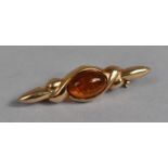 A Pretty Gilt Silver and Amber Brooch in the Form of a Knot. 4.1cms Long