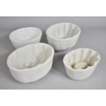 A Collection of Four White Glazed Vintage Stoneware Jelly Moulds