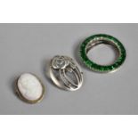 A Silver Clip with Green Stones, a Silver Mounted Cameo Brooch a Oval Silver Brooch Stamped KH-98