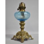 A Late Victorian Brass Based Oil Lamp with Blue Glass Reservoir, 34cm High