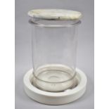 An Unusual Counter Top Cylindrical Glass Shop Jar on Circular Ceramic Base and with Marble Cover,