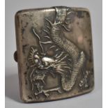 A Chinese White Metal Cigarette Case Decorated in relief with Snarling Dragon. 93.8cms