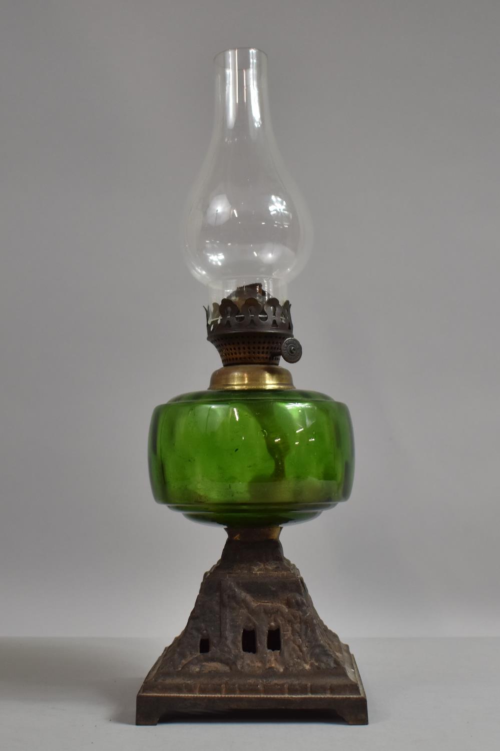 A Late Victorian Cast Iron Based Oil Lamp with Green Glass Reservoir, 43cm High