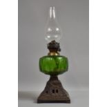 A Late Victorian Cast Iron Based Oil Lamp with Green Glass Reservoir, 43cm High