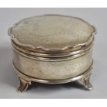 A Circular Silver Dressing Table Box with Swag and Ribbon Decoration to Hinged Lid, Four Scrolled