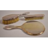 A Silver Mounted Dressing Table Set Comprising Two Brushes and a Hand Mirror