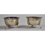 A Pair of Late Victorian Silver Salts with Cobalt Blue Glass Liners on Three Scrolled Pad Feet,