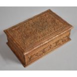 An Intricately Carved Puzzle Box with Hinged Lid to Two Division Interior, 21cm wide