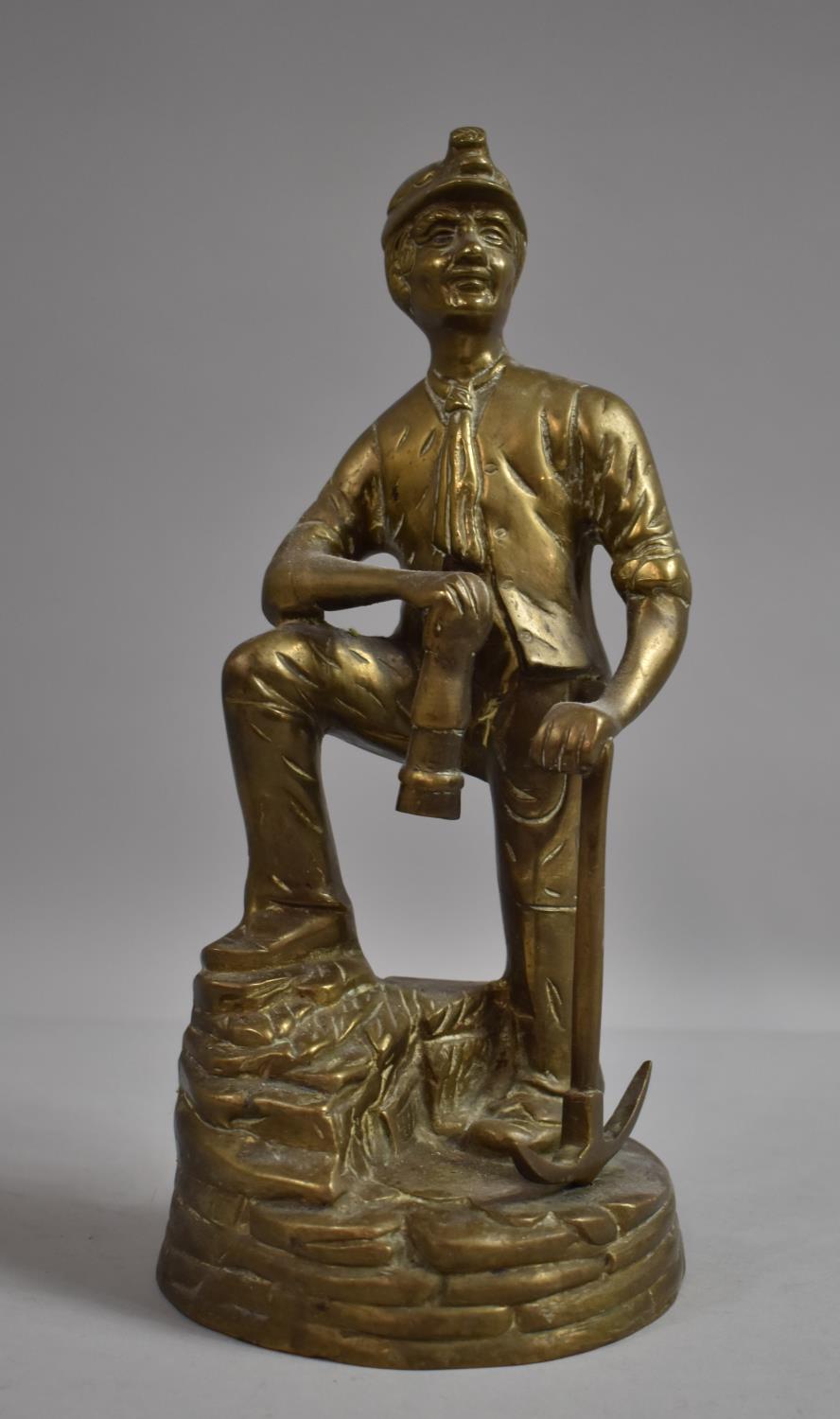 A Mid/Late 20th Century Heavy Brass Study of a Miner with Pickaxe, 30cm high