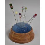 A Modern Turned Wooden Pin Cushion with Collection of Various Hatpins