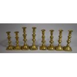 A Set of Four Pairs of Brass Candlesticks