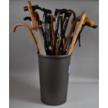 A Tapering Waste Bin or Stick Stand Containing Large Quantity of Walking Sticks of Various Types and