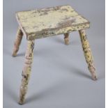 A Vintage Cream Painted Rectangular Topped Milking Stool on Four Turned Supports, 25cm Wide