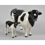 A Beswick Friesian Cow and Calf