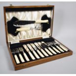 An Edwardian Oak Cased Canteen Containing Six Fish Knives, Forks and Servers, 34.5cm wide