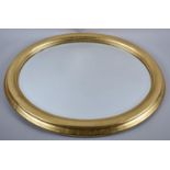 A Gilt Framed Oval Wall Mirror, 58x48cm