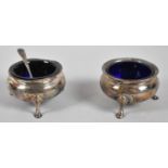 A Pair of Circular Silver Salts on Three Feet with Cobalt Blue Glass Liners, One Spoon