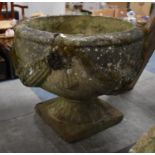 A Reconstituted Stone Planter of Urn Form with Moulded Swag Decoration Raised on Plinth Base,