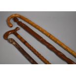 A Collection of Four Wooden Walking Sticks to Include to Include African Example, Carved Example etc