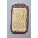 A Japanese Carved Wood and Bone Tablet Decorated in Relief with Exterior Scene, Inset Signed Disk to