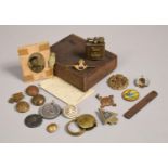A Vintage Cigar Box Containing Various Enamel and Other Military Badges, Cigarette Lighter,