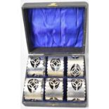 An Edwardian Cased Set of Six Silver Plated Napkin Rings with Pierced Decoration