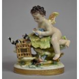 A Continental Porcelain Study of Cherub with Kitten and Bird from Cage, 13cm high