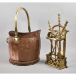 A Modern Copper and Brass Helmet Shaped Coal Scuttle Containing Brass Fire Companion Set
