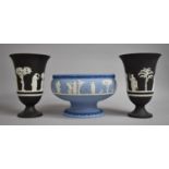 A Wedgwood Blue Jasperware Pedestal Bowl, 21cm Diameter and a Pair of Black Jasperware Vases